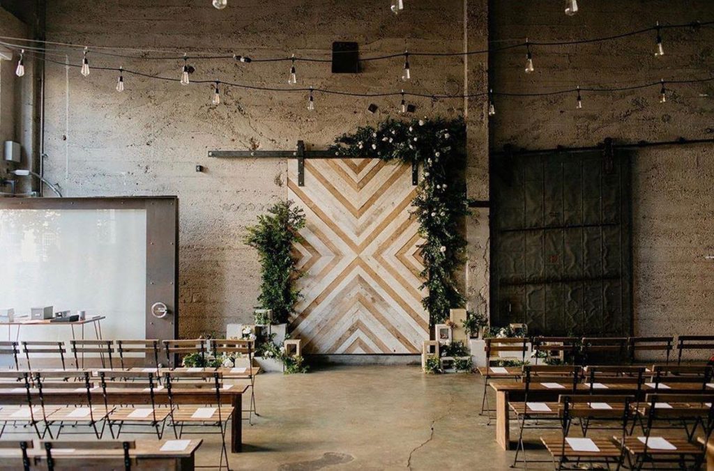 industrial ceremony setup with twinkle lights in luce loft in san diego