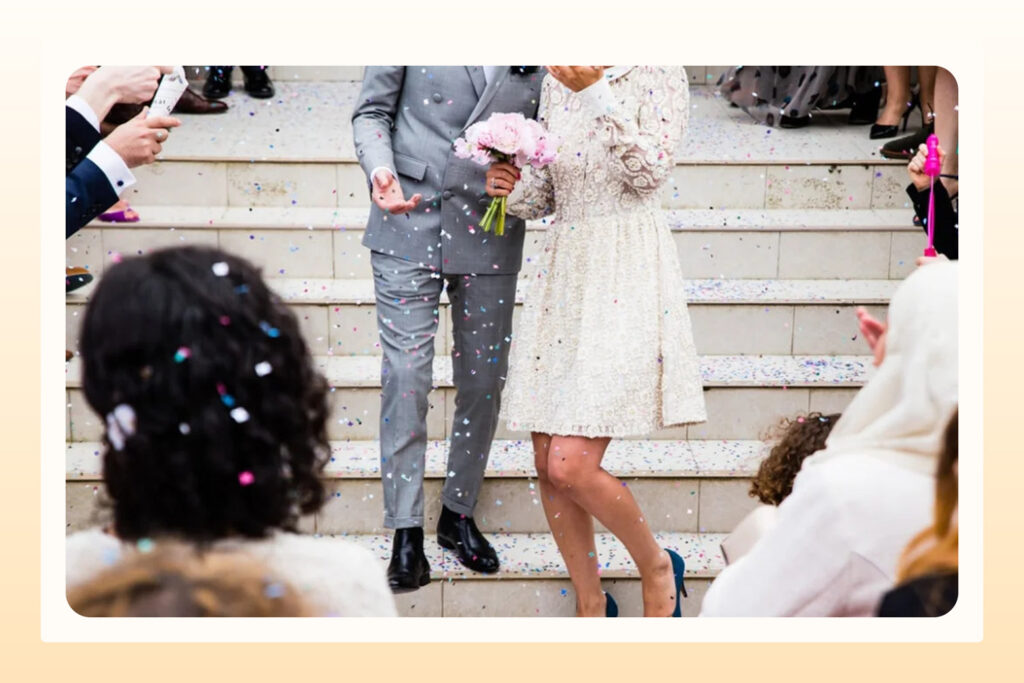 married couple surrounded by guests on their wedding day