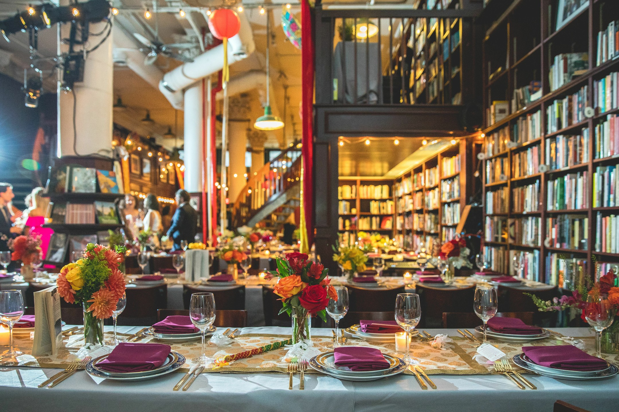 dinner reception table set with books surrounding